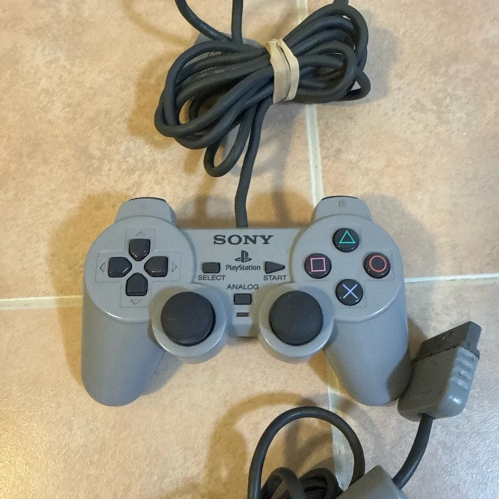 Sony Gray PlayStation Console with Two Wired Gray Controllers